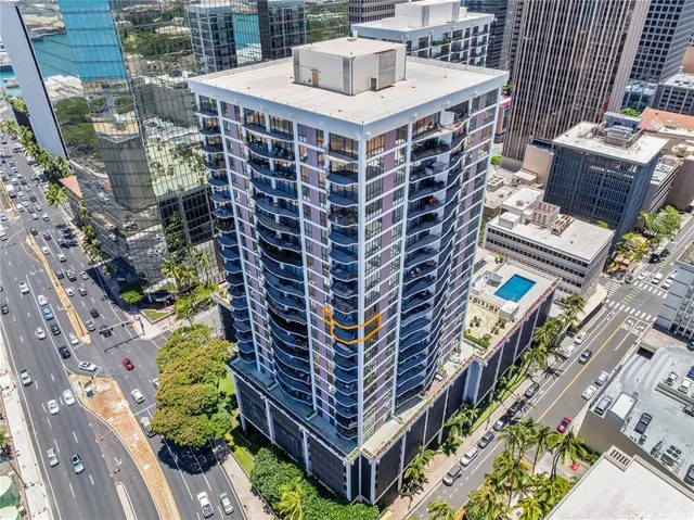 a front view of a multi story building with yard