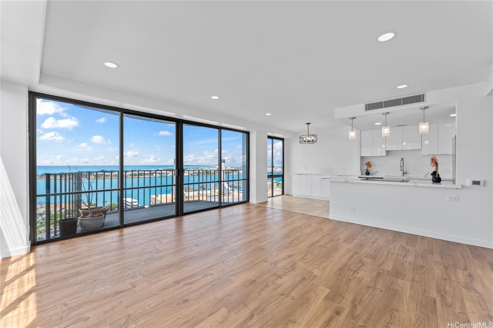 700 Richards Street, Unit 1709 Honolulu, HI 96813 - Photo 3 of 25 a view of a kitchen with large windows and a chandelier