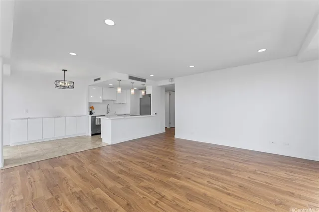 a view of a kitchen with a sink and wooden floor