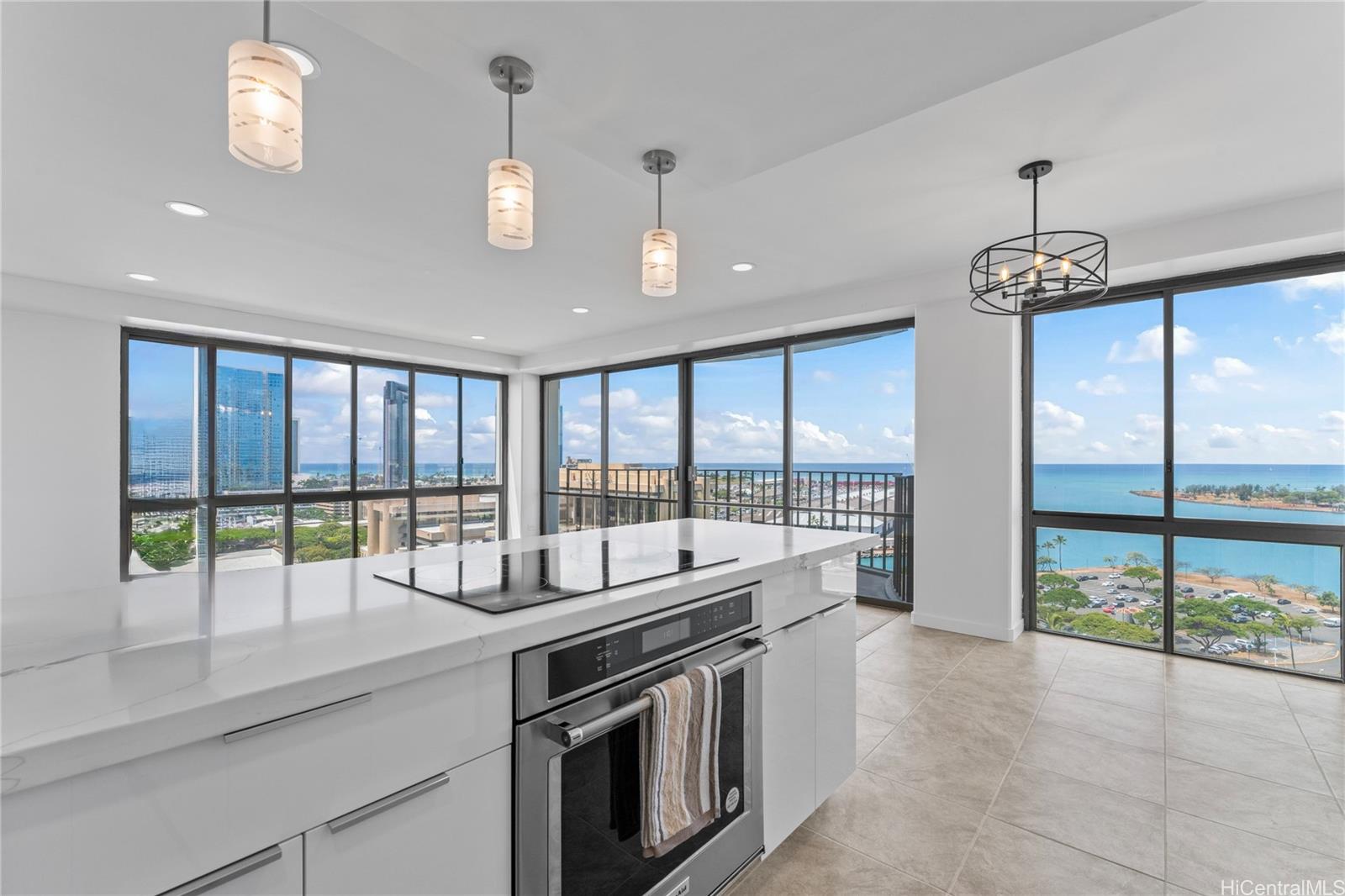 700 Richards Street, Unit 1709 Honolulu, HI 96813 - Photo 9 of 25 a dining hall with stainless steel appliances granite countertop a stove and a view of living room