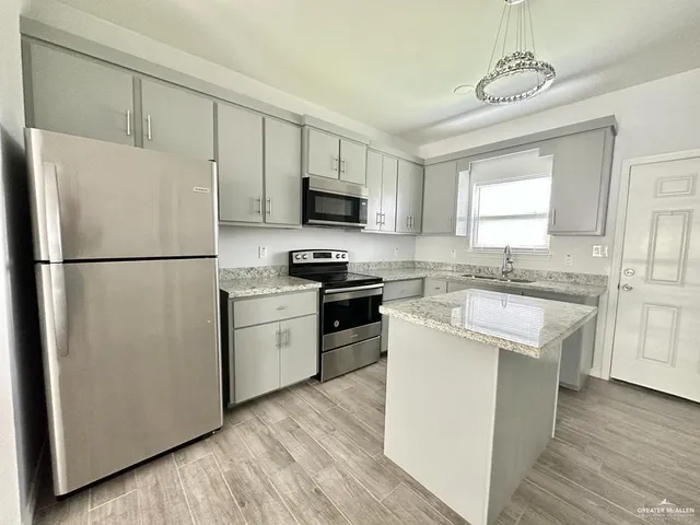 a kitchen with a refrigerator stove and microwave