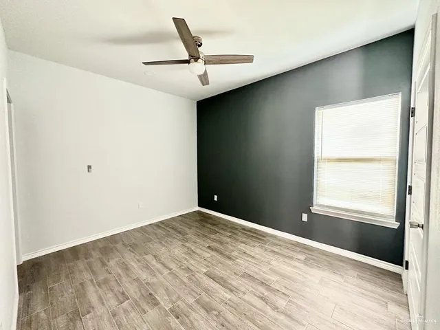a kitchen with a granite countertop sink and refrigerator