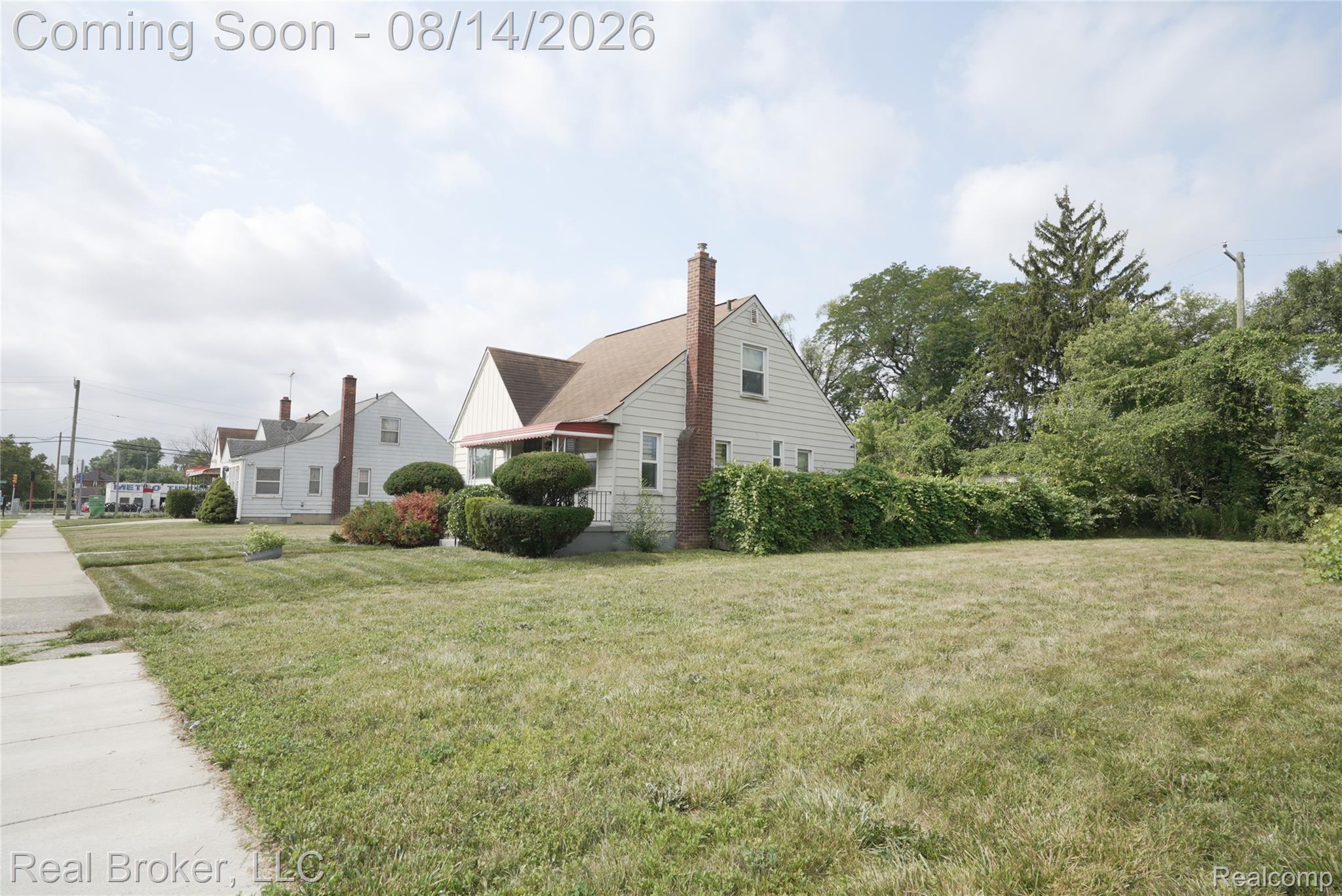 9557 Meyers Road Detroit, MI 48227 - Photo 6 of 23 Expansive front lawn with established landscaping, a brick chimney, and a side yard with mature trees