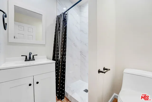 a bathroom with a sink toilet and shower