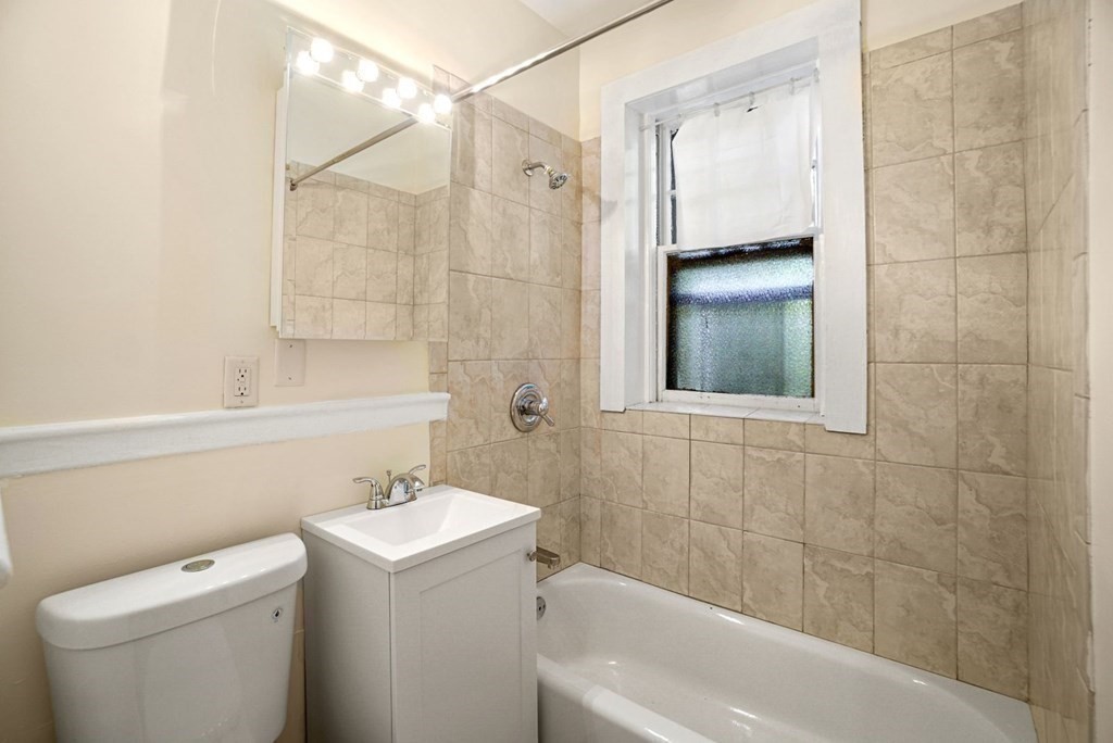 55 Lanark Road, Unit 6 Boston, MA 02135 - Photo 11 of 12 a bathroom with a sink a toilet and shower