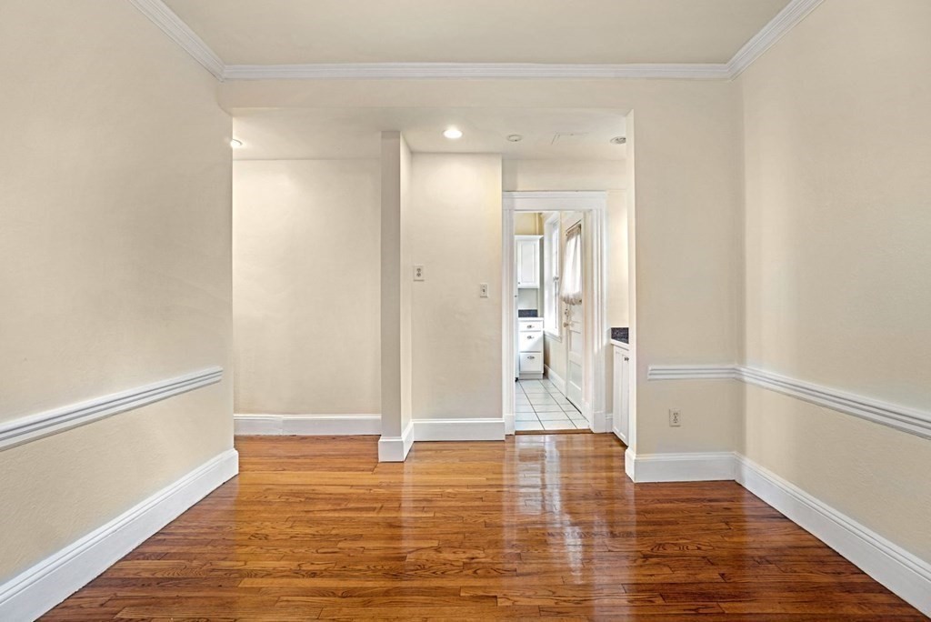 55 Lanark Road, Unit 6 Boston, MA 02135 - Photo 4 of 12 a view of empty room with wooden floor
