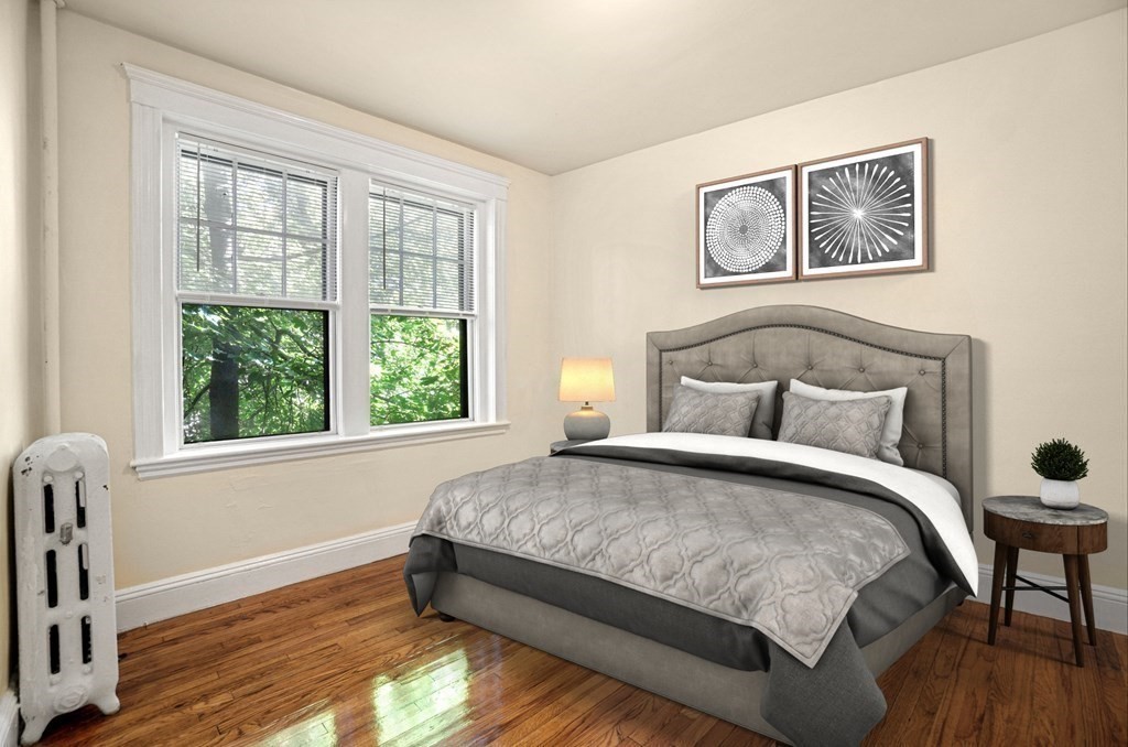 55 Lanark Road, Unit 6 Boston, MA 02135 - Photo 8 of 12 a bedroom with a bed and a large window