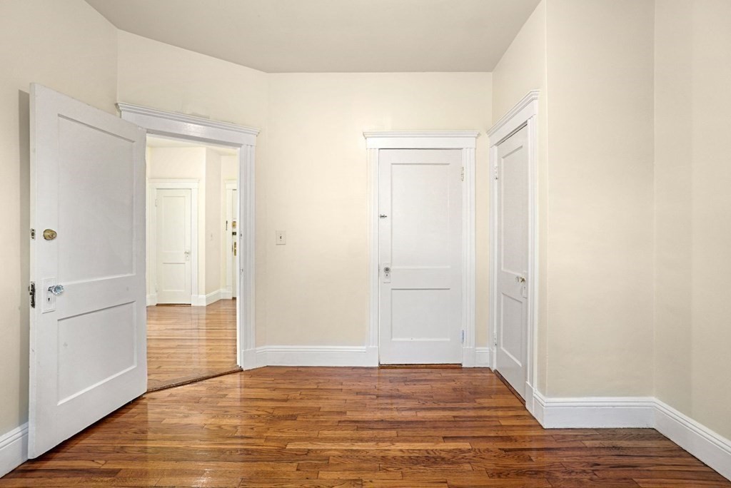 55 Lanark Road, Unit 6 Boston, MA 02135 - Photo 10 of 12 a view of an empty room with wooden floor and closet