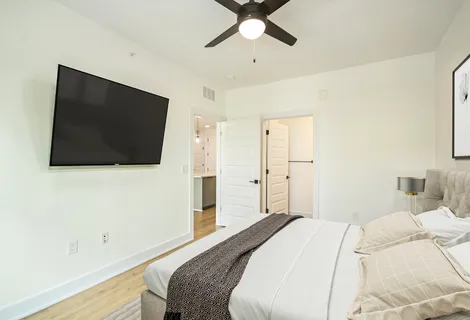 a bedroom with a bed and a flat screen tv