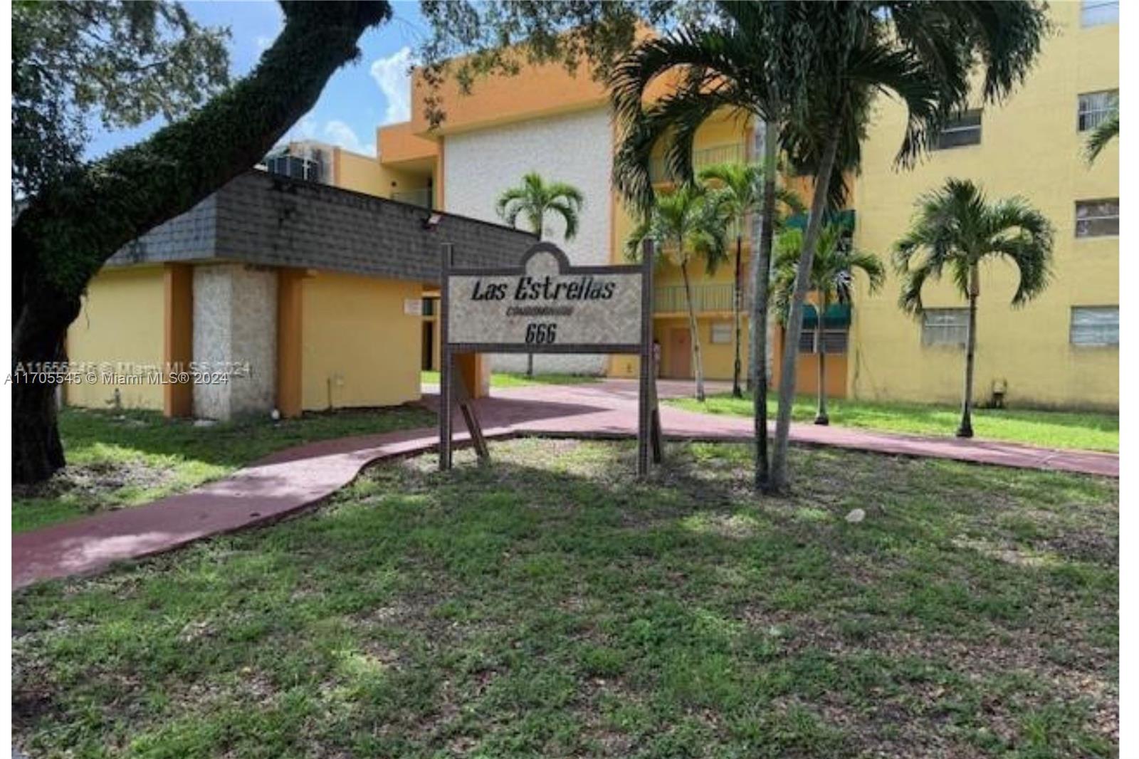 666 West 81st Street, Unit 418 Hialeah, FL 33014 - Photo 1 of 9 a view of a house with a yard