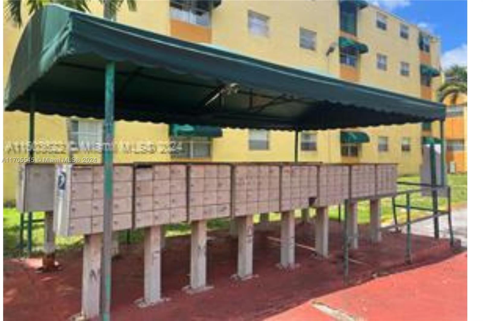 666 West 81st Street, Unit 418 Hialeah, FL 33014 - Photo 2 of 9 a view of a patio with table and chairs under an umbrella