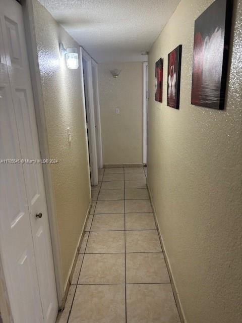 666 West 81st Street, Unit 418 Hialeah, FL 33014 - Photo 4 of 9 a view of hallway with stairs