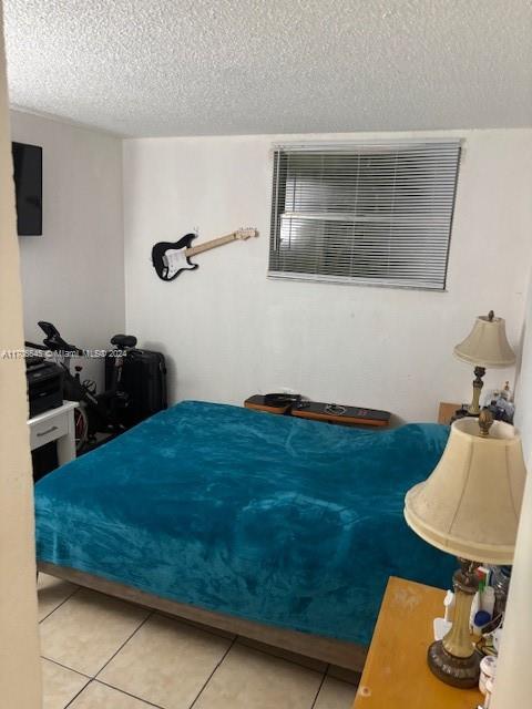 666 West 81st Street, Unit 418 Hialeah, FL 33014 - Photo 5 of 9 a bedroom with a bed and dresser