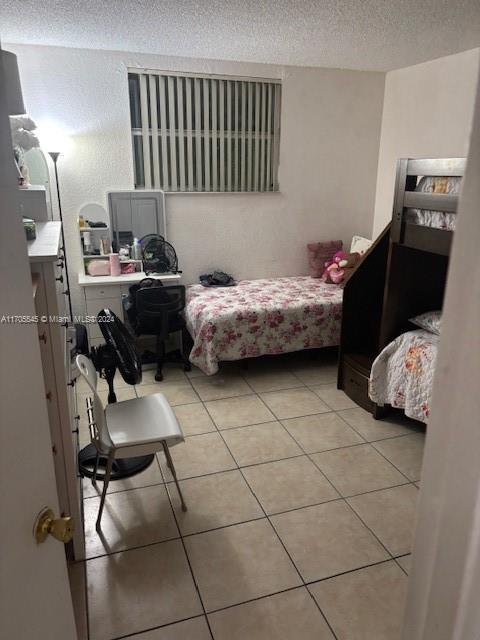 666 West 81st Street, Unit 418 Hialeah, FL 33014 - Photo 6 of 9 a bedroom with a bed and a couch