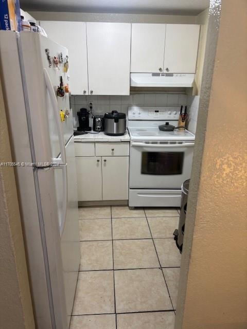 666 West 81st Street, Unit 418 Hialeah, FL 33014 - Photo 7 of 9 a kitchen with a refrigerator sink and cabinets
