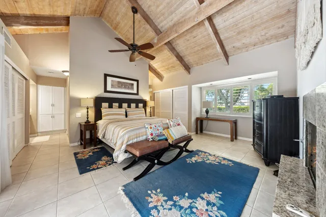 a bedroom with a bed dresser and a large window