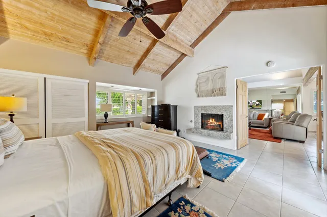 a spacious bedroom with a balcony a bed and a fireplace