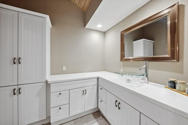 a bathroom with a double vanity sink and mirror