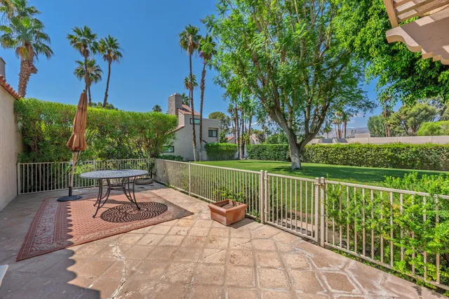 a view of a chairs and table in the garden