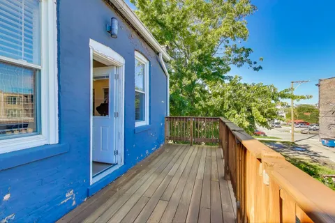 a balcony with wooden floor and outdoor space