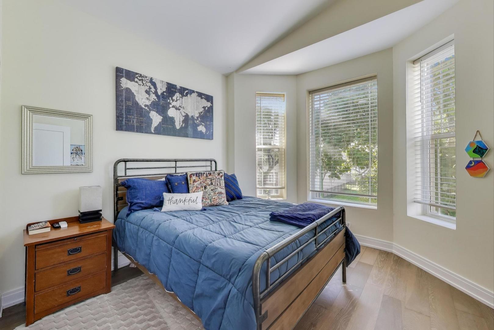 6511 South Evans Avenue Chicago, IL 60637 - Photo 17 of 30 a bed sitting in a bedroom next to a window