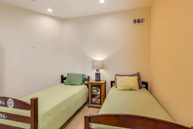 a bedroom with a bed and a night stand