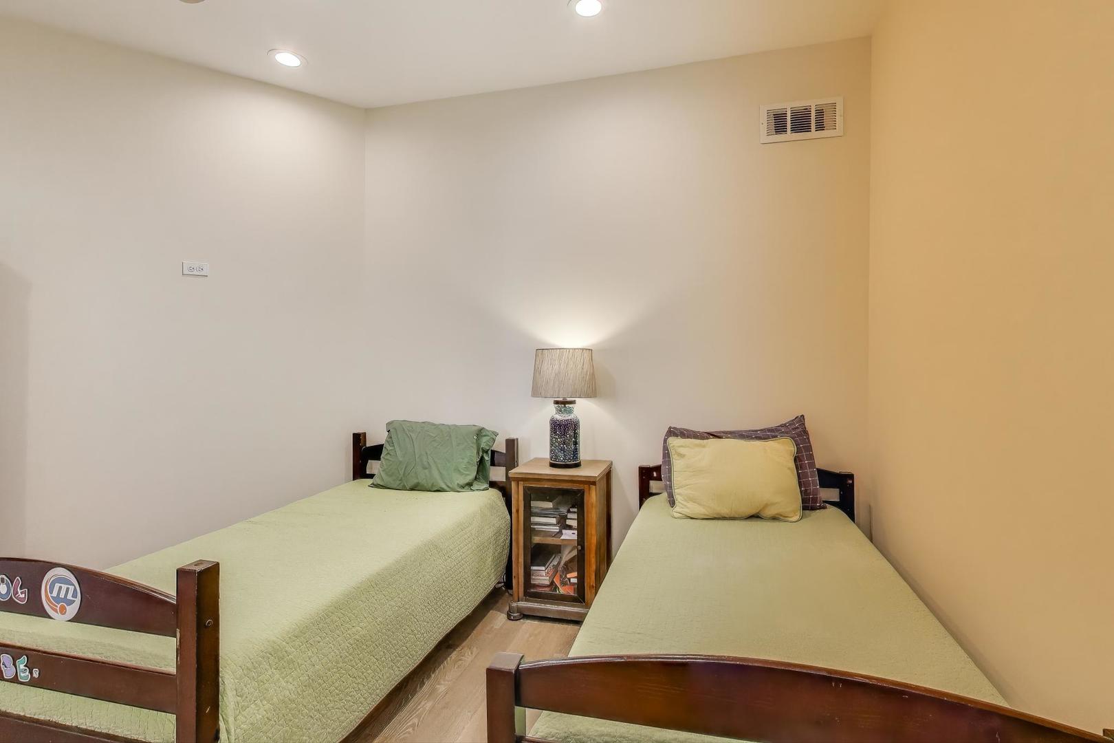 6511 South Evans Avenue Chicago, IL 60637 - Photo 18 of 30 a bedroom with a bed and a night stand