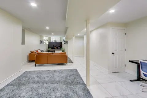 a room with stainless steel appliances kitchen island a sink and a refrigerator