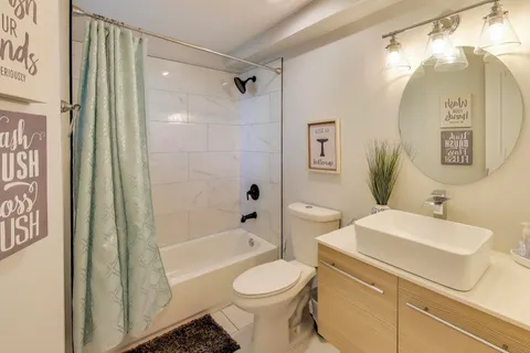 a bathroom with a sink toilet and shower
