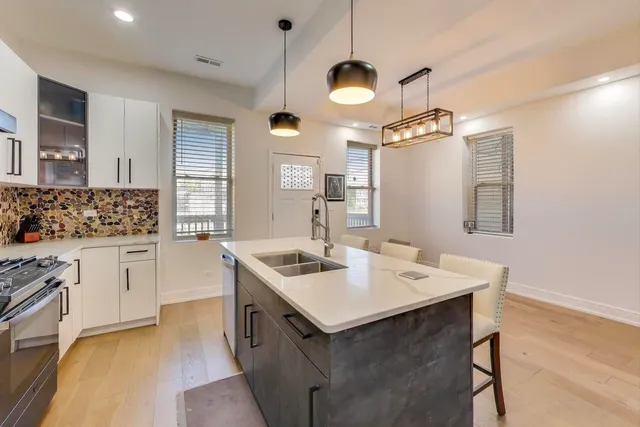 a kitchen with a sink stove and microwave