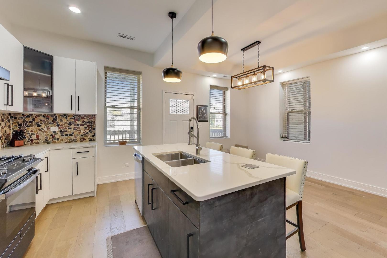 6511 South Evans Avenue Chicago, IL 60637 - Photo 8 of 30 a kitchen with a sink stove and microwave