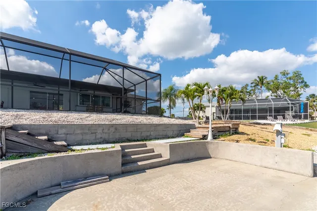a view of a house with swimming pool and a sitting area