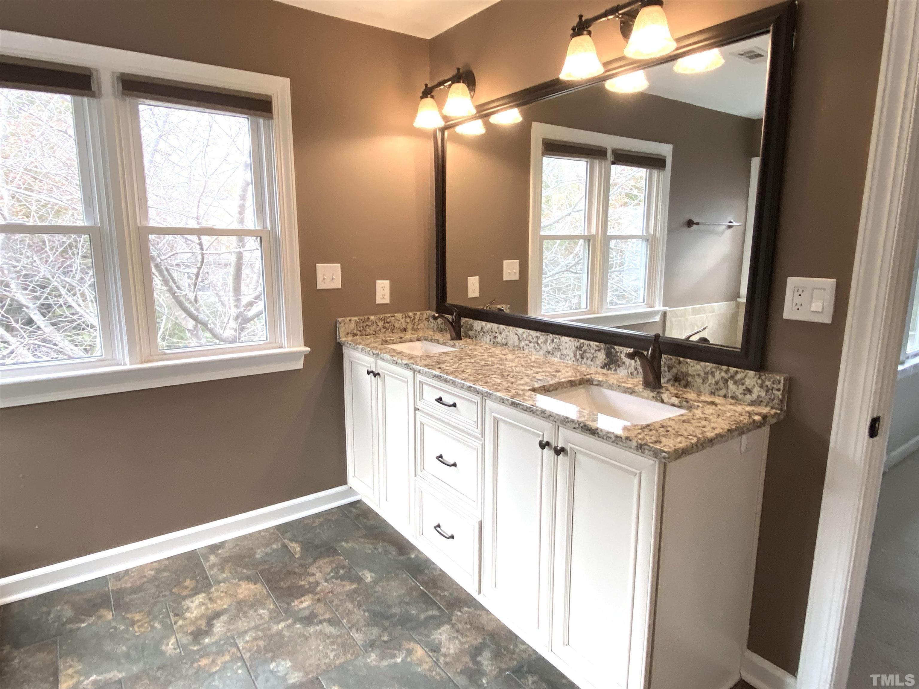 4313 Fowler Ridge Drive Raleigh, NC 27616 - Photo 13 of 30 a bathroom with a sink vanity and a mirror