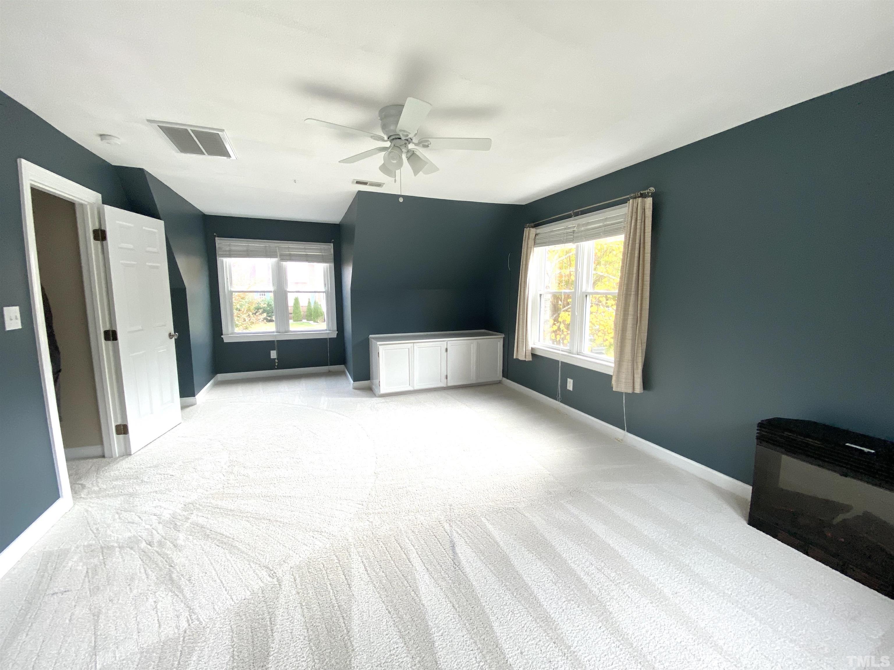 4313 Fowler Ridge Drive Raleigh, NC 27616 - Photo 21 of 30 a spacious bedroom with a large bed and a window