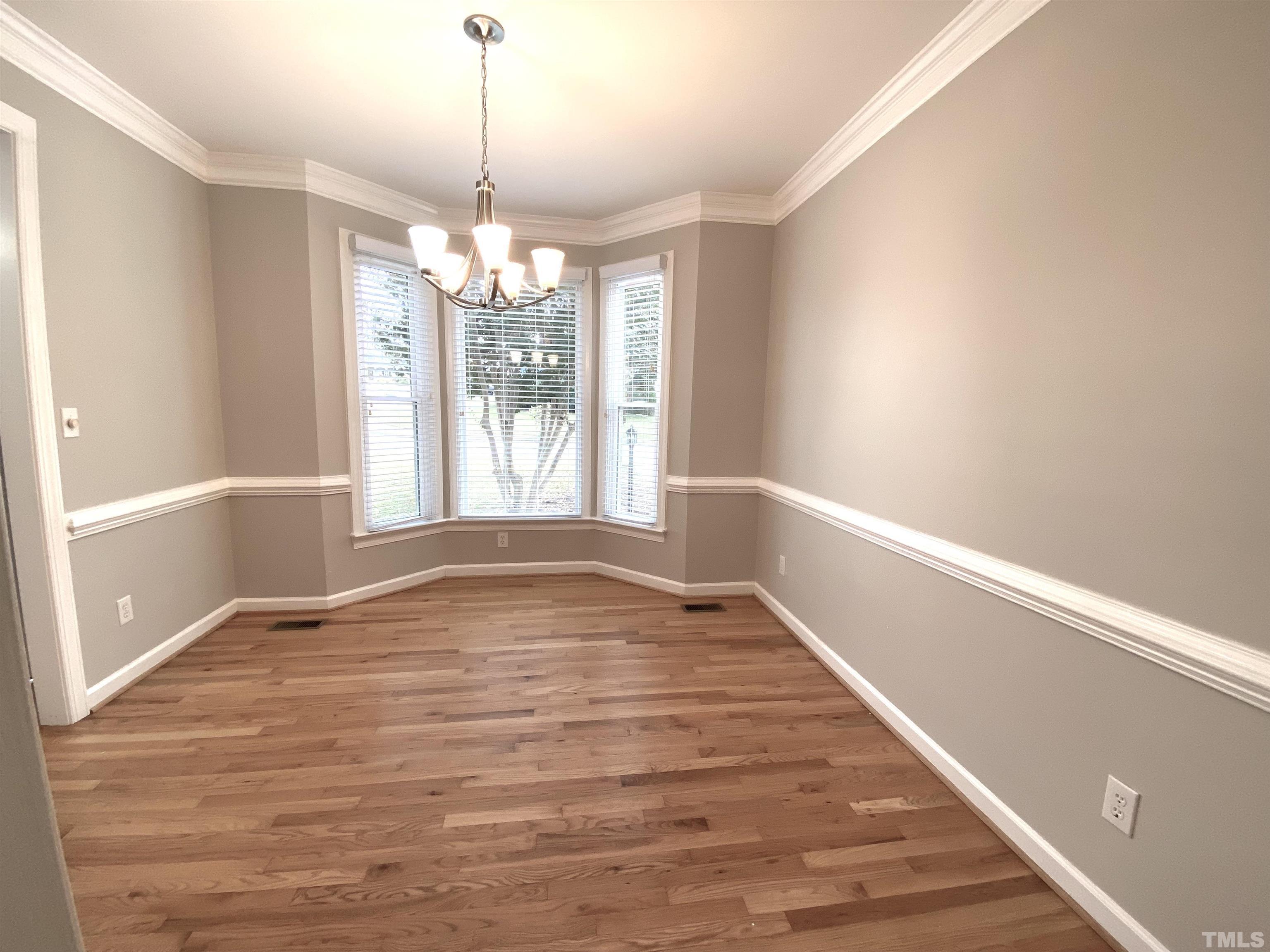 4313 Fowler Ridge Drive Raleigh, NC 27616 - Photo 4 of 30 a view of an empty room with wooden floor and a window