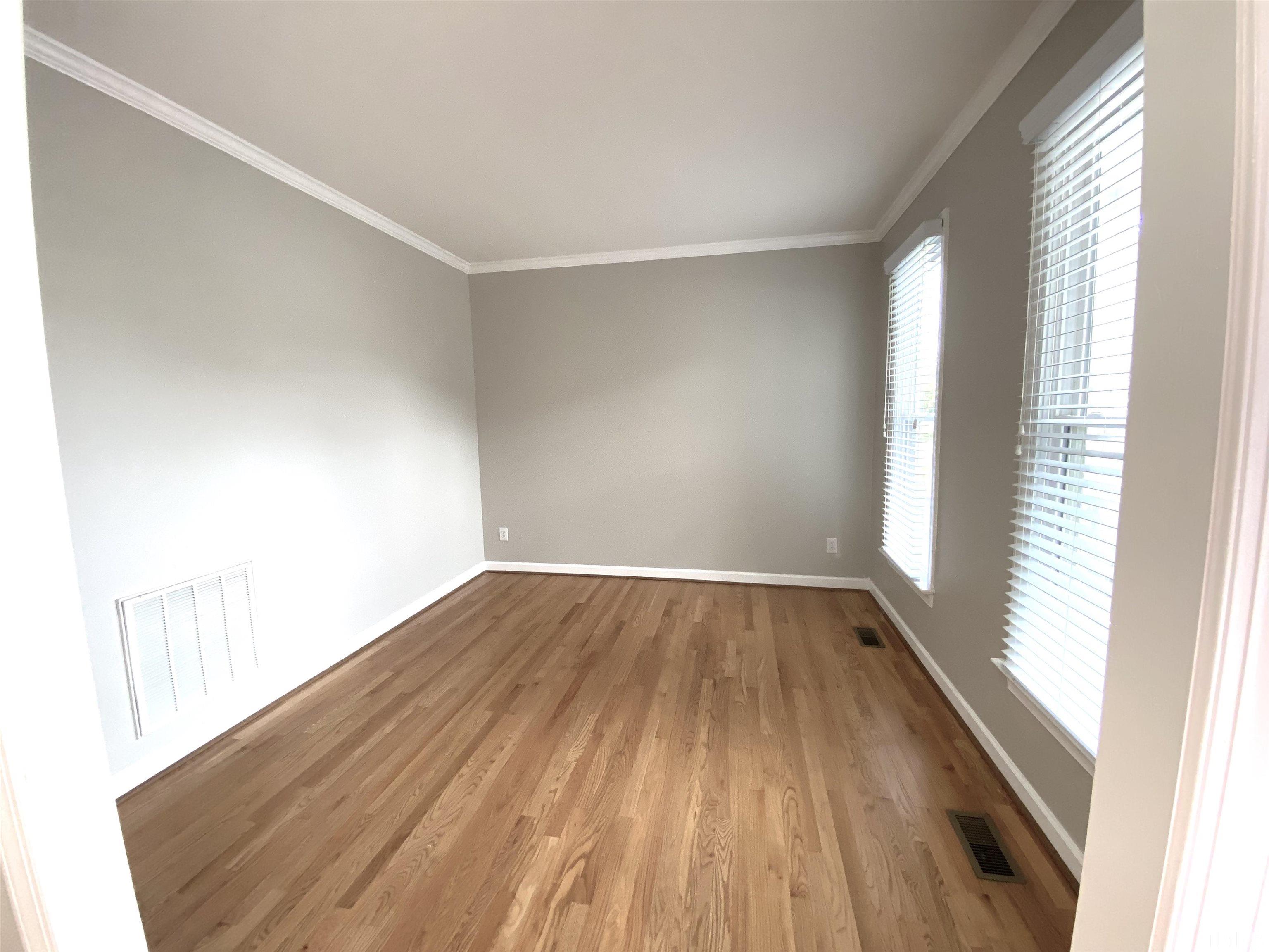 4313 Fowler Ridge Drive Raleigh, NC 27616 - Photo 5 of 30 an empty room with wooden floor and windows