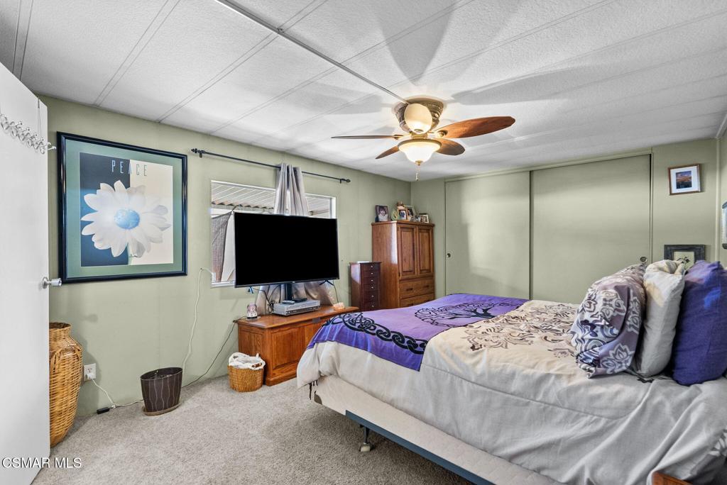 1550 Rory Lane, Unit 239 Simi Valley, CA 93063 - Photo 19 of 37 a bedroom with a bed and a flat screen tv