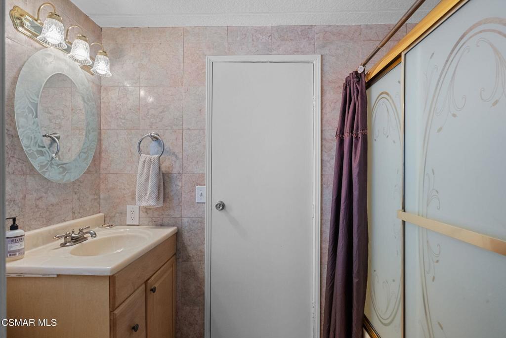 1550 Rory Lane, Unit 239 Simi Valley, CA 93063 - Photo 24 of 37 a bathroom with a sink and a mirror