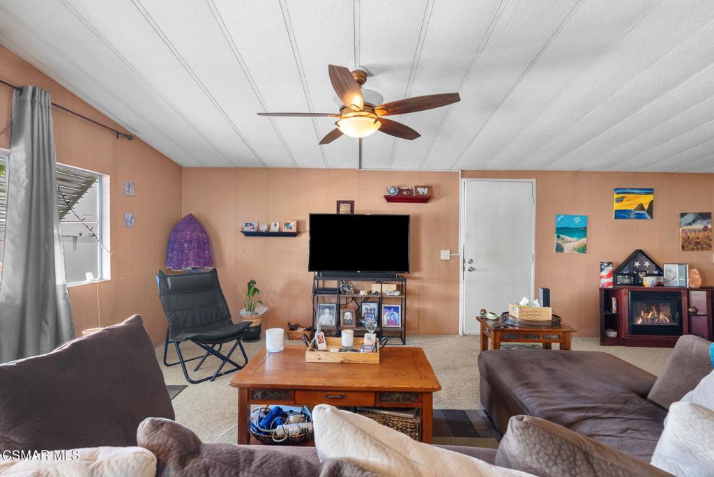 1550 Rory Lane, Unit 239 Simi Valley, CA 93063 - Photo 8 of 37 a living room with furniture and a flat screen tv