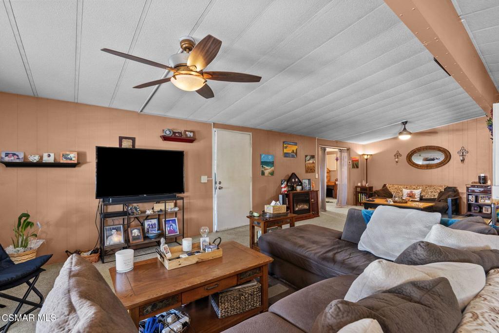 1550 Rory Lane, Unit 239 Simi Valley, CA 93063 - Photo 9 of 37 a living room with furniture and a flat screen tv