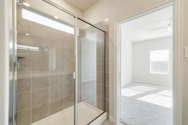 a bathroom with a glass shower door