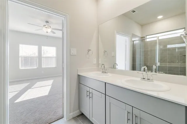 a bathroom with a sink double vanity and a mirror