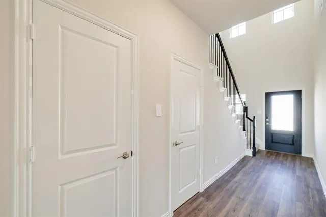 a view of a hallway with wooden floor