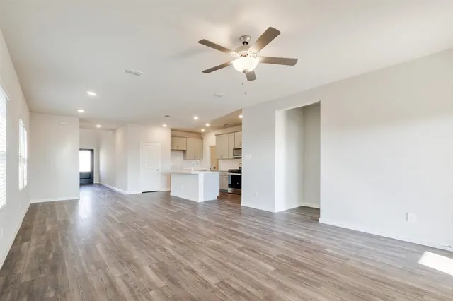 a view of a kitchen with wooden floor and a window