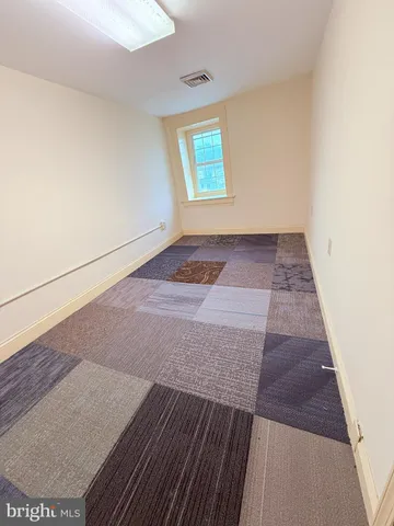 an empty room with wooden floor