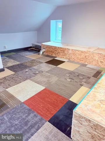 a view of an empty room and wooden floor