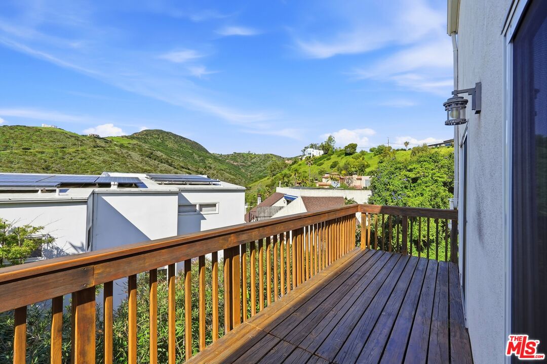 2955 Corral Canyon Road Malibu, CA 90265 - Photo 6 of 21 a view of a balcony with wooden floor and fence