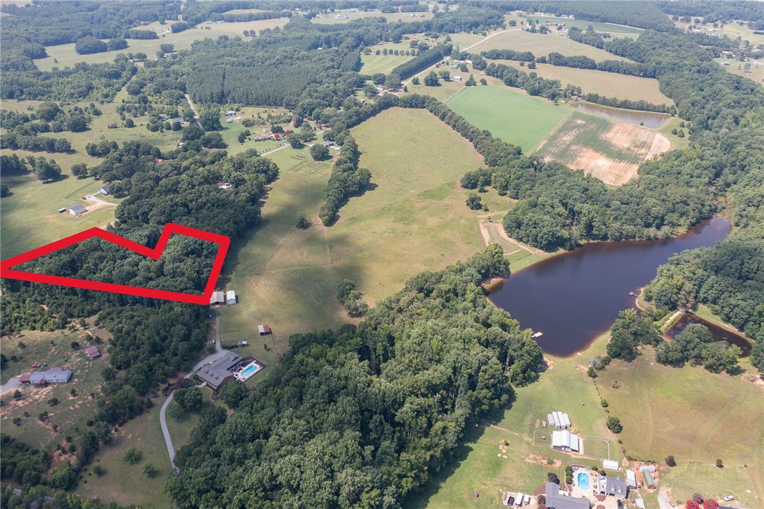 Lot 9 Locke Road Belton, SC 29627 - Photo 3 of 3 Sprawling acreage features a private pond, mature woodlands, and open fields for diverse activities.