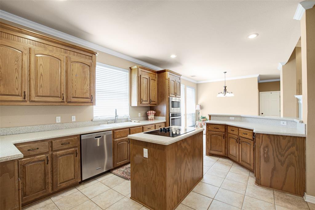 850 Turquoise Point Rockwall, TX 75032 - Photo 14 of 40 a kitchen with stainless steel appliances granite countertop a sink counter space cabinets and a large window