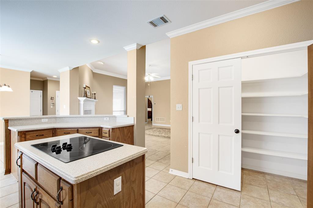 850 Turquoise Point Rockwall, TX 75032 - Photo 15 of 40 a kitchen that has a sink a stove and a table in it